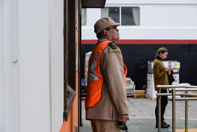 Young man looking away while standing on bus