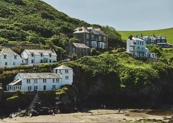 Plants and buildings against sky at port isaac in cornwall, england