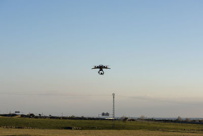 Low angle view of helicopter flying in sky