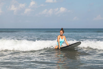 Man surfing on sea against sky