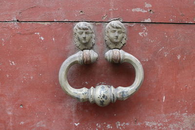 Close-up of door knocker on wall