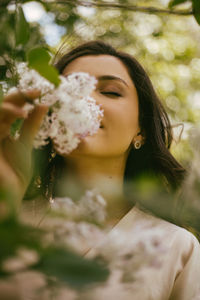 Portrait of woman with pink flower