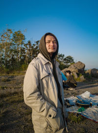 Portrait of men standing against clear sky