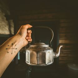 Close-up of hand holding kettle