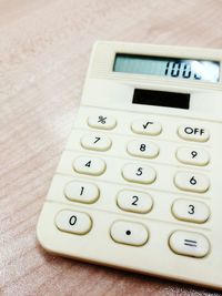 Directly above shot of calculator on wooden table