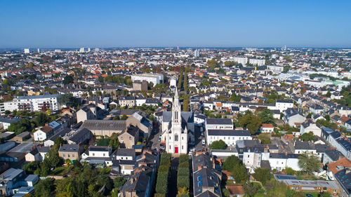 Aerial view of town against clear blue sky