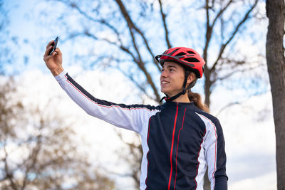 Male athlete taking selfie while standing park