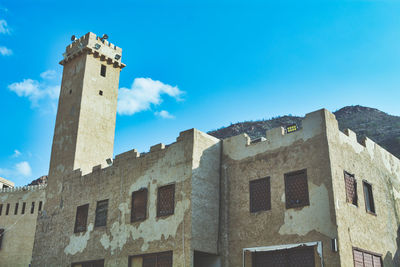 Low angle view of a historic building under a blue sky