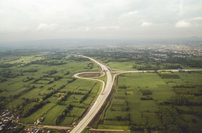 High angle view of malang toll road amidst field against sky