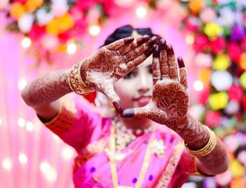 Close-up of woman with pink butterfly