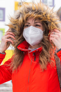 Portrait of young woman wearing hat with ffp2 protective mask. quarantine lifestyle.