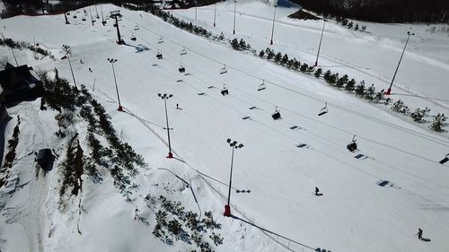 High angle view of people skiing on snowcapped mountain