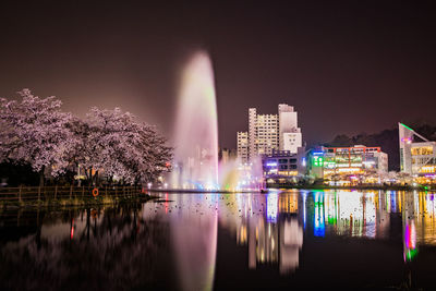 Reflection of illuminated buildings in water at night