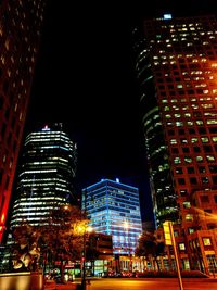Low angle view of skyscrapers lit up at night