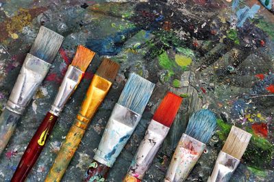 Close-up of paintbrushes on dirty table