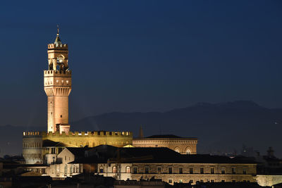 Illuminated building against sky at night