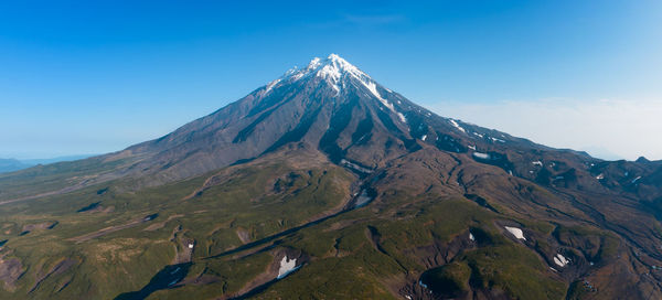 Scenic view of mountains against clear blue sky