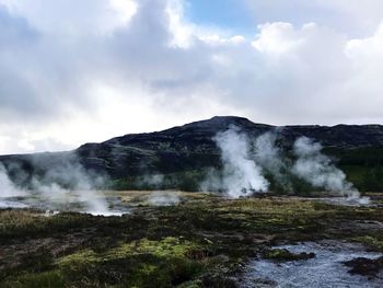 Scenic view of waterfall against sky