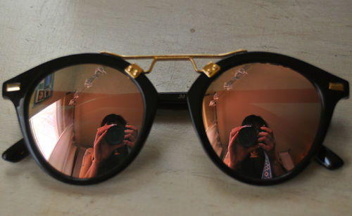 Close-up of sunglasses on mirror