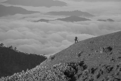 Man on mountain against sky