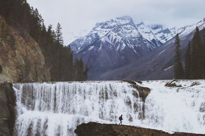 Scenic view of waterfall against sky during winter