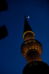 Low angle view of tower of building against blue sky