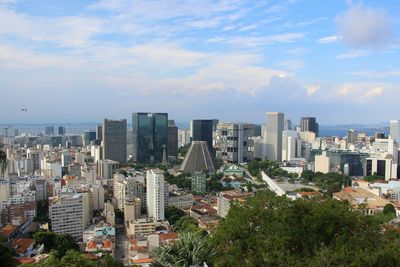 View of cityscape against cloudy sky