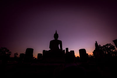 Silhouette temple against sky during sunset