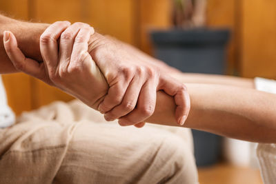 Thai yoga massage - close up of male and female hands holding