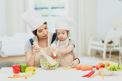 Woman having food in kitchen