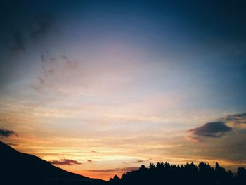 Low angle view of silhouette trees against sky during sunset