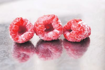 Close-up of strawberries on table against white background