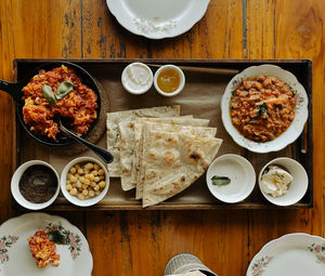 Oriental food on a served table, shakshuka, beans, bread
