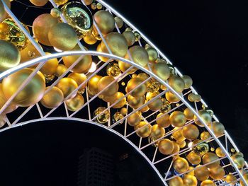 Low angle view of decorations at night