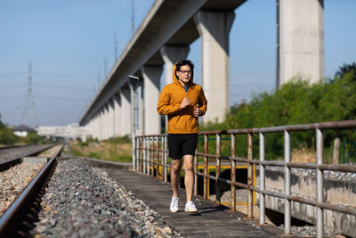 Full length of man running on bridge