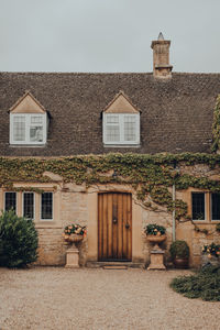 Facade of a traditional english cottage in broadway, cotswolds, uk.