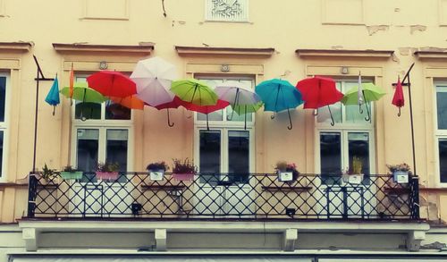 Colorful umbrellas hanging on building
