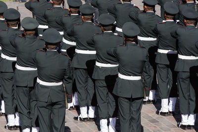 Rear view of police marching during parade