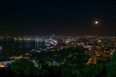 High angle view of illuminated buildings against sky at night