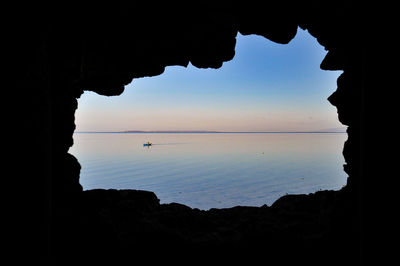 Scenic view of sea seen through cave