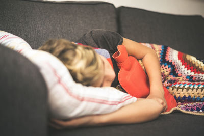 Boy sleeping on sofa at home