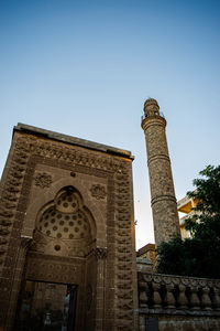 Low angle view of historical building against clear blue sky