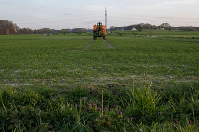 Scenic view of farm on field against sky