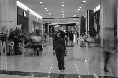 People in illuminated corridor