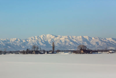 Scenic view of snowcapped mountains against clear sky