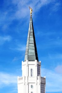 Low angle view of cross on building against sky