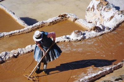 High angle view of woman working at salt flat