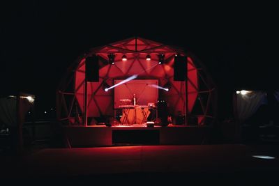 Illuminated red lights in dark room