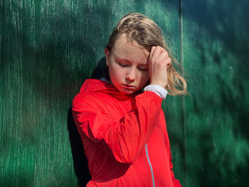 Girl looking away while standing outdoors