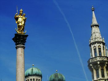 Low angle view of statue against blue sky